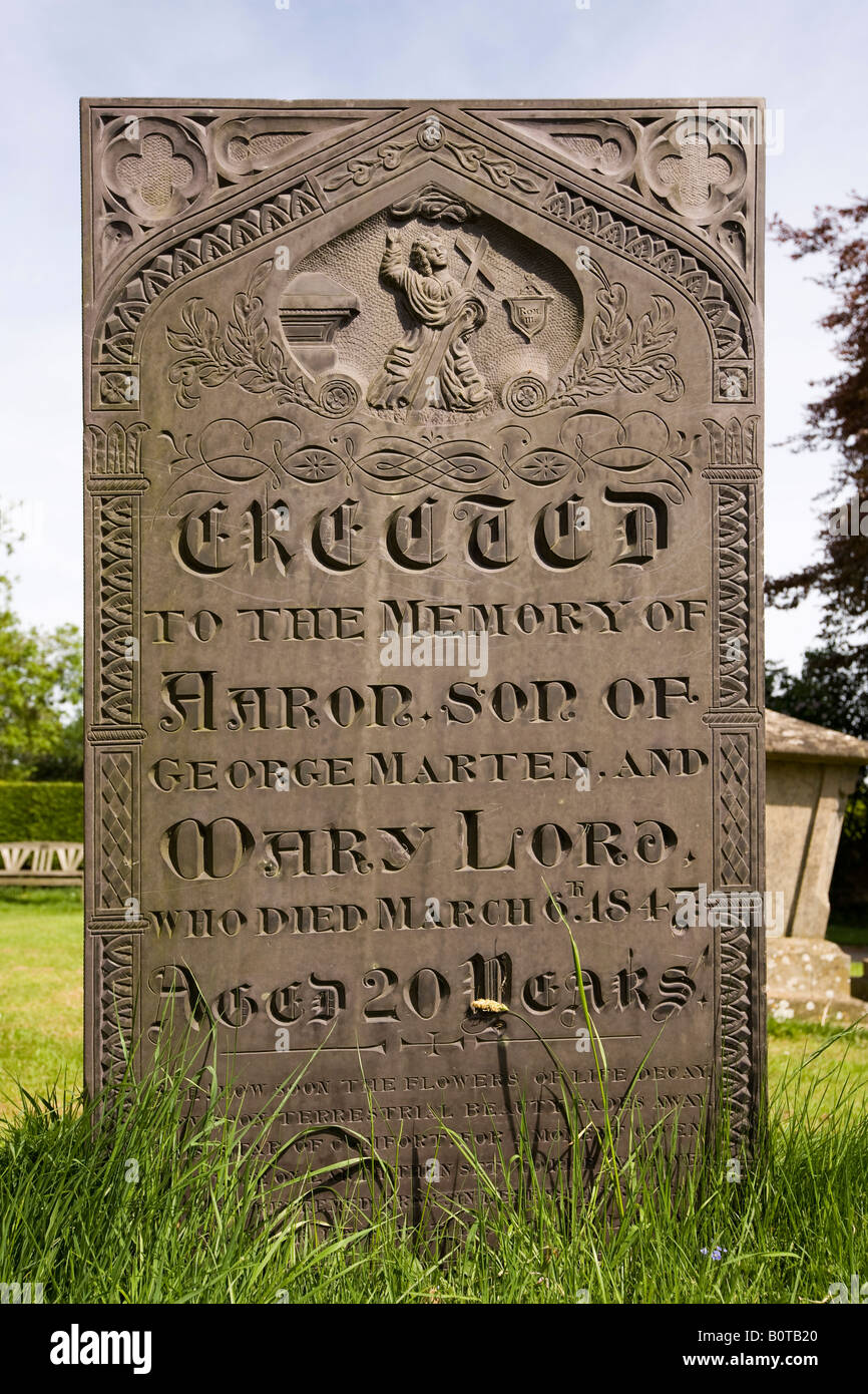 UK England Lincolnshire Harlaxton Parish Churchyard old slate gravestone with christ and crucifix carving Stock Photo