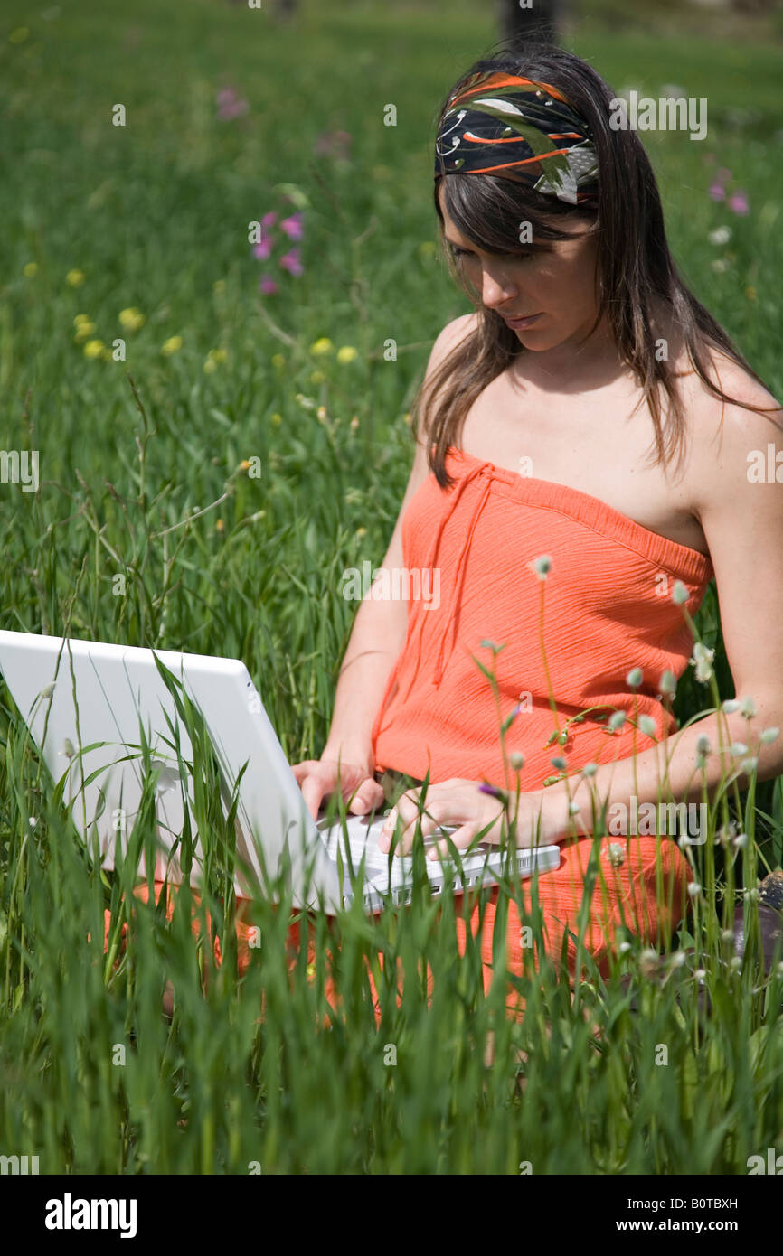 young woman using a laptop in the countryside Stock Photo - Alamy
