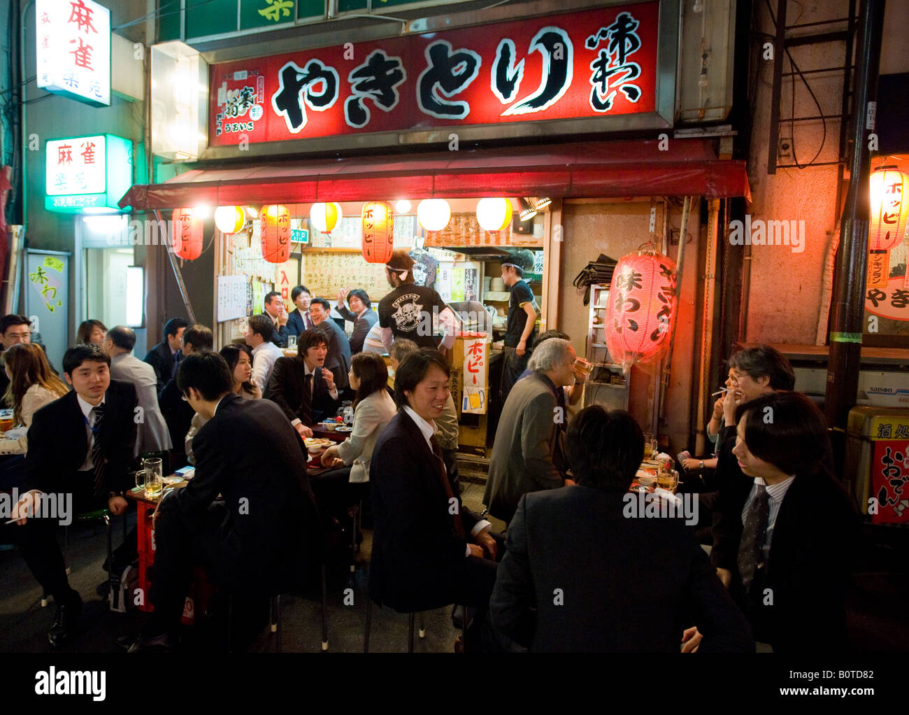Busy izakaya restaurant under railway tracks at Yurakucho in central Tokyo Japan Stock Photo