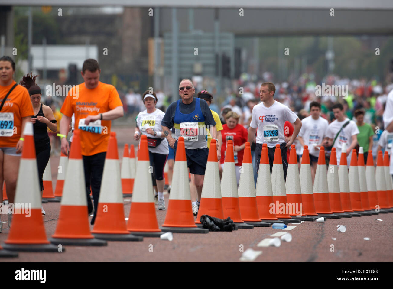 competitors running behind traffic cone lane markers during the belfast