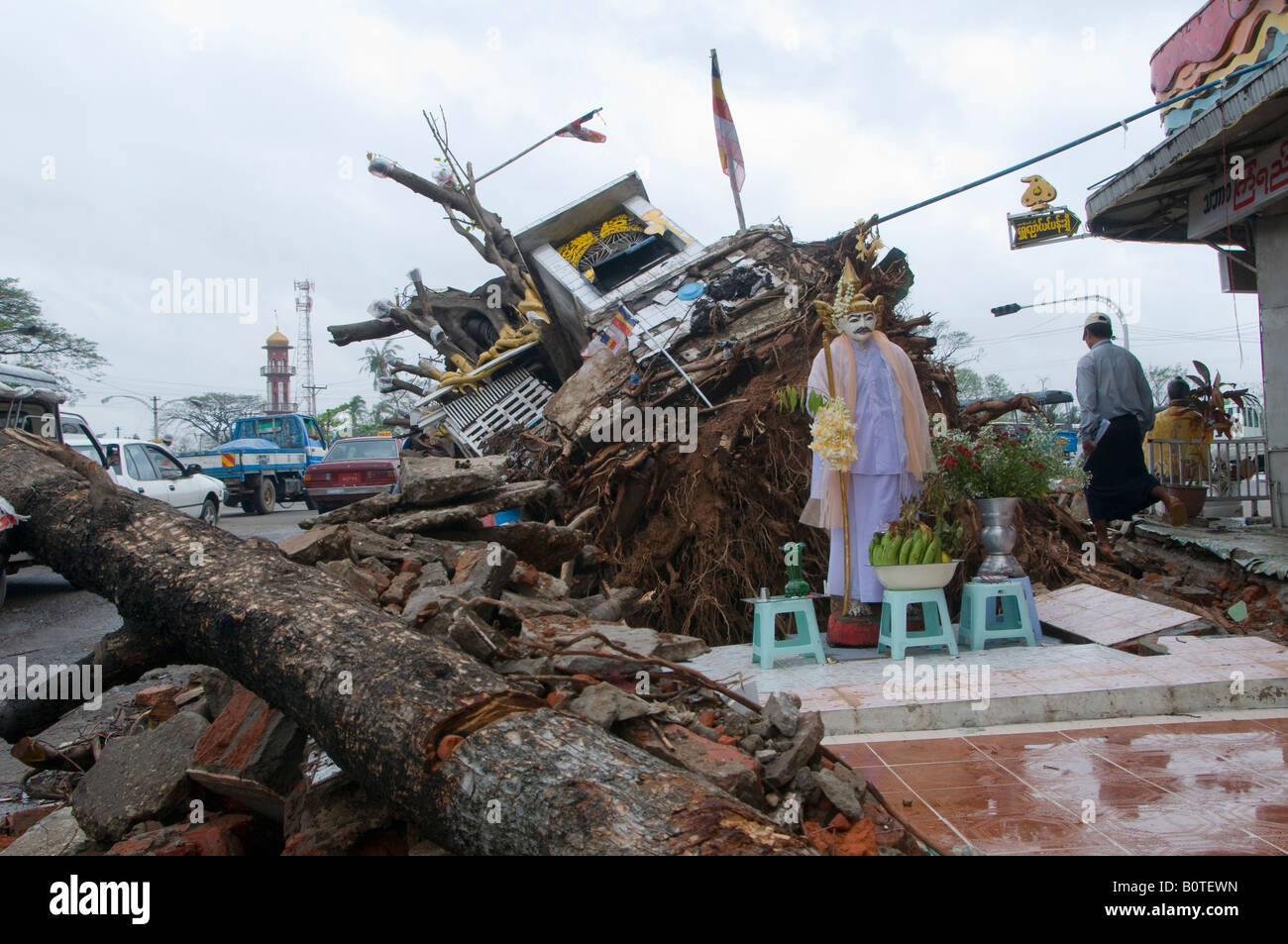 Buddhist statue stands among damage caused by tropical cyclone Nargis in center of Yangon, Myanmar,  Burma Stock Photo