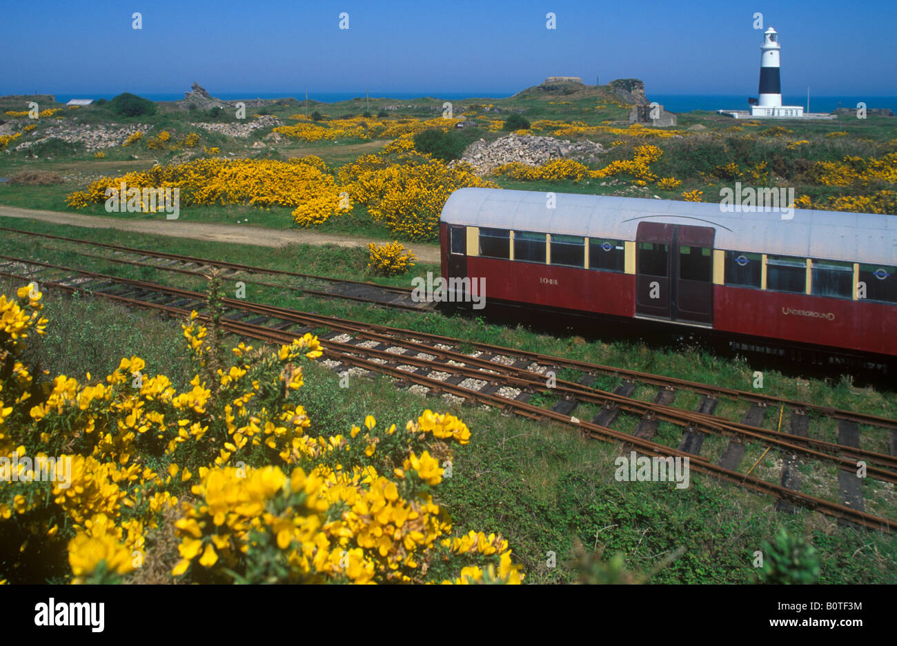 train in front of the lighthouse, Alderney Island Stock Photo