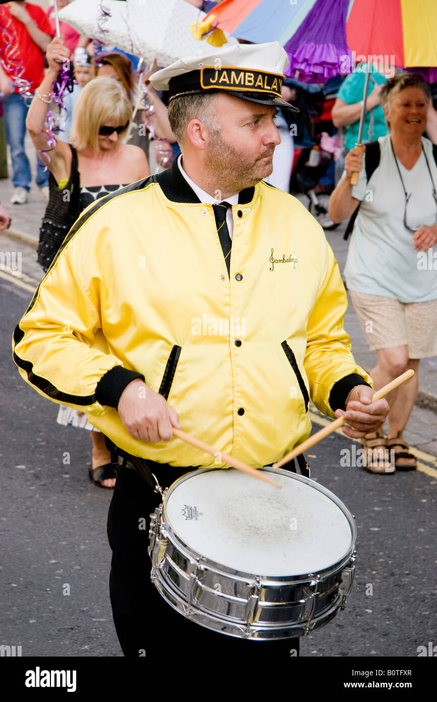 Drummer of a street band marching through The Barbican Plymouth England Stock Photo