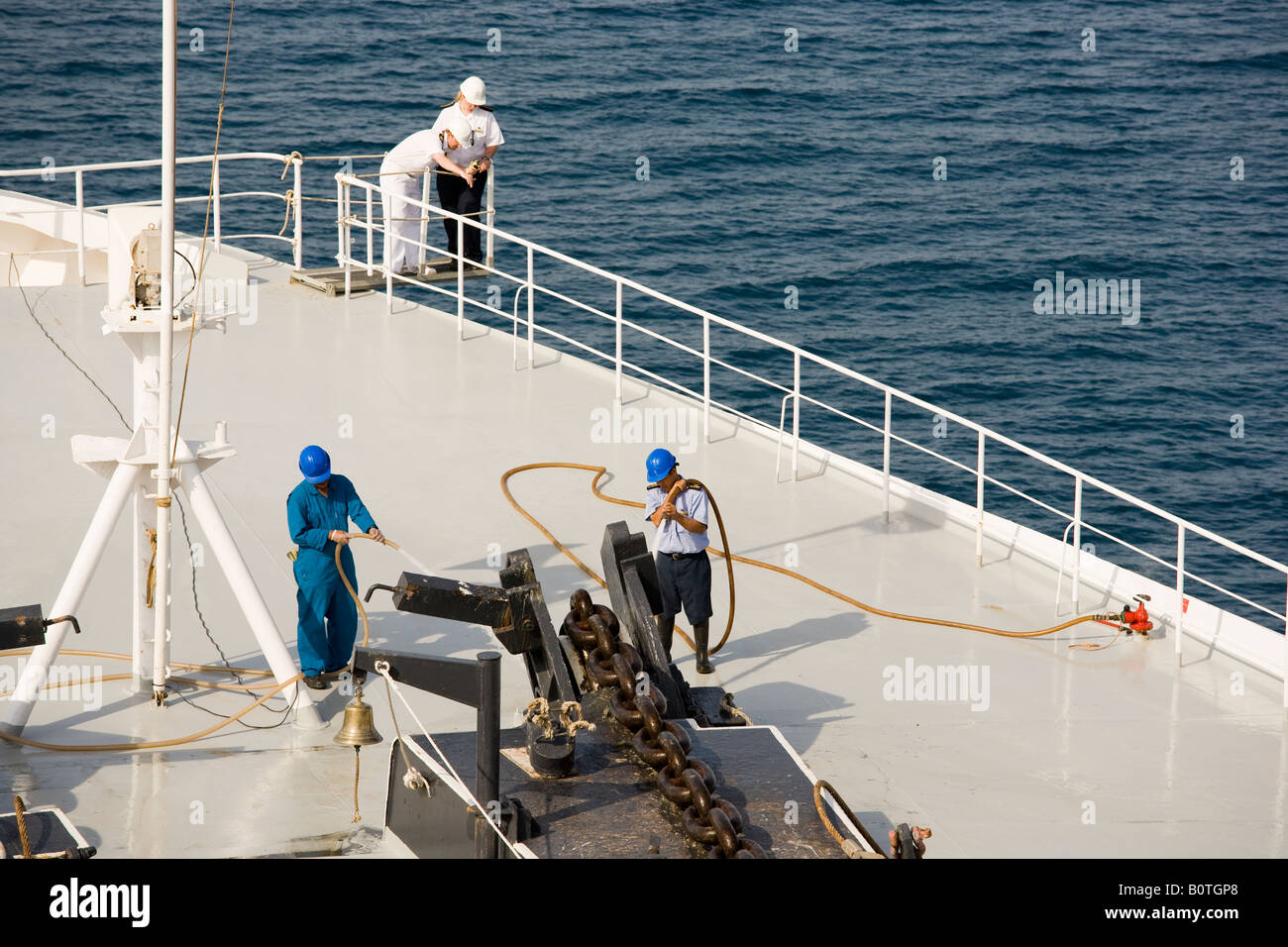 Cunard QE2 bow bring up the anchor chain deck officers points position of anchor to deck cadet Stock Photo
