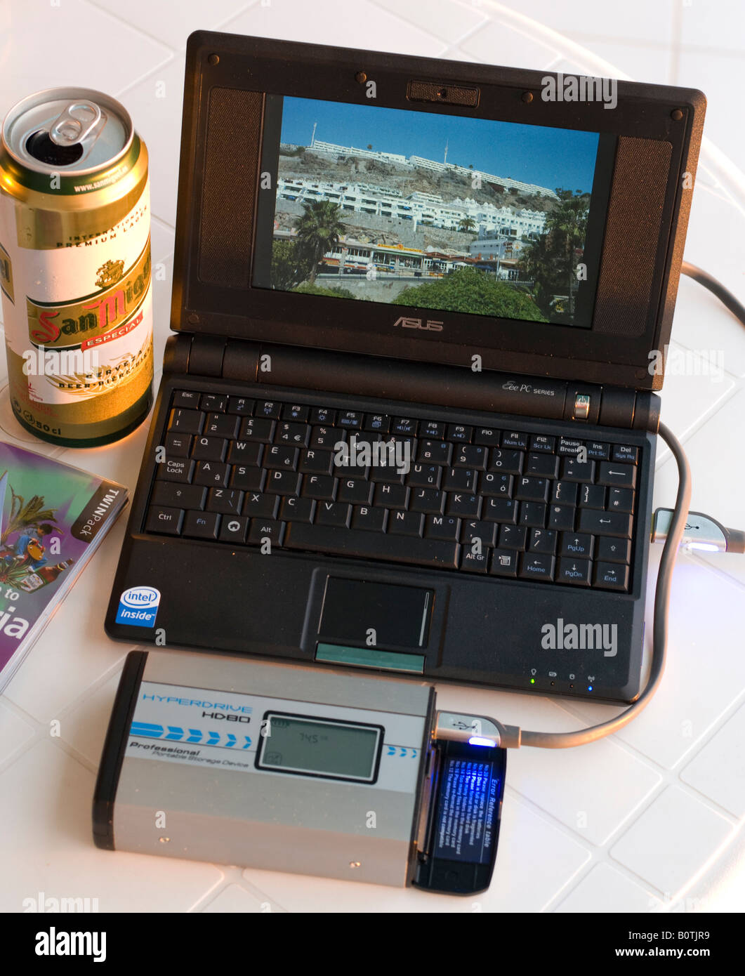 Gran Canaria - using an Eee PC solis state sub laptop connected to a Hyperdrive image storage hard disk to view pictures Stock Photo