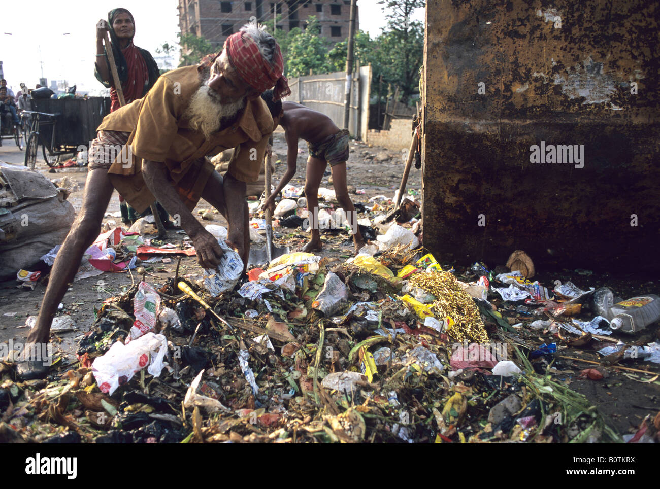 Rubbish collectors sift through the public waste in Dacca the capital