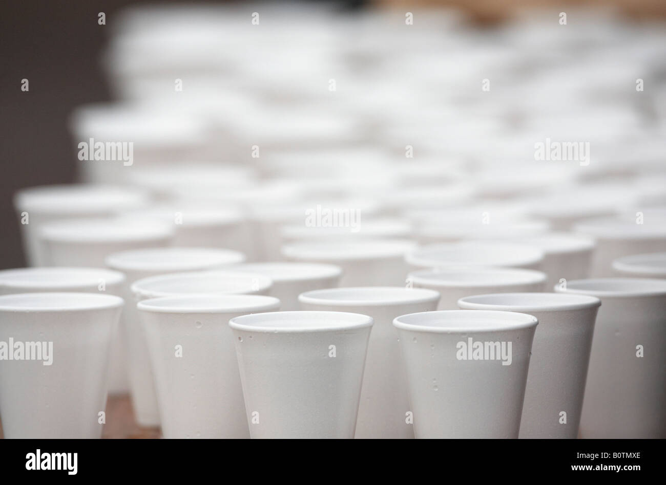 polystyrene styrofoam cups full of water sitting on a table during a marathon sports race Stock Photo