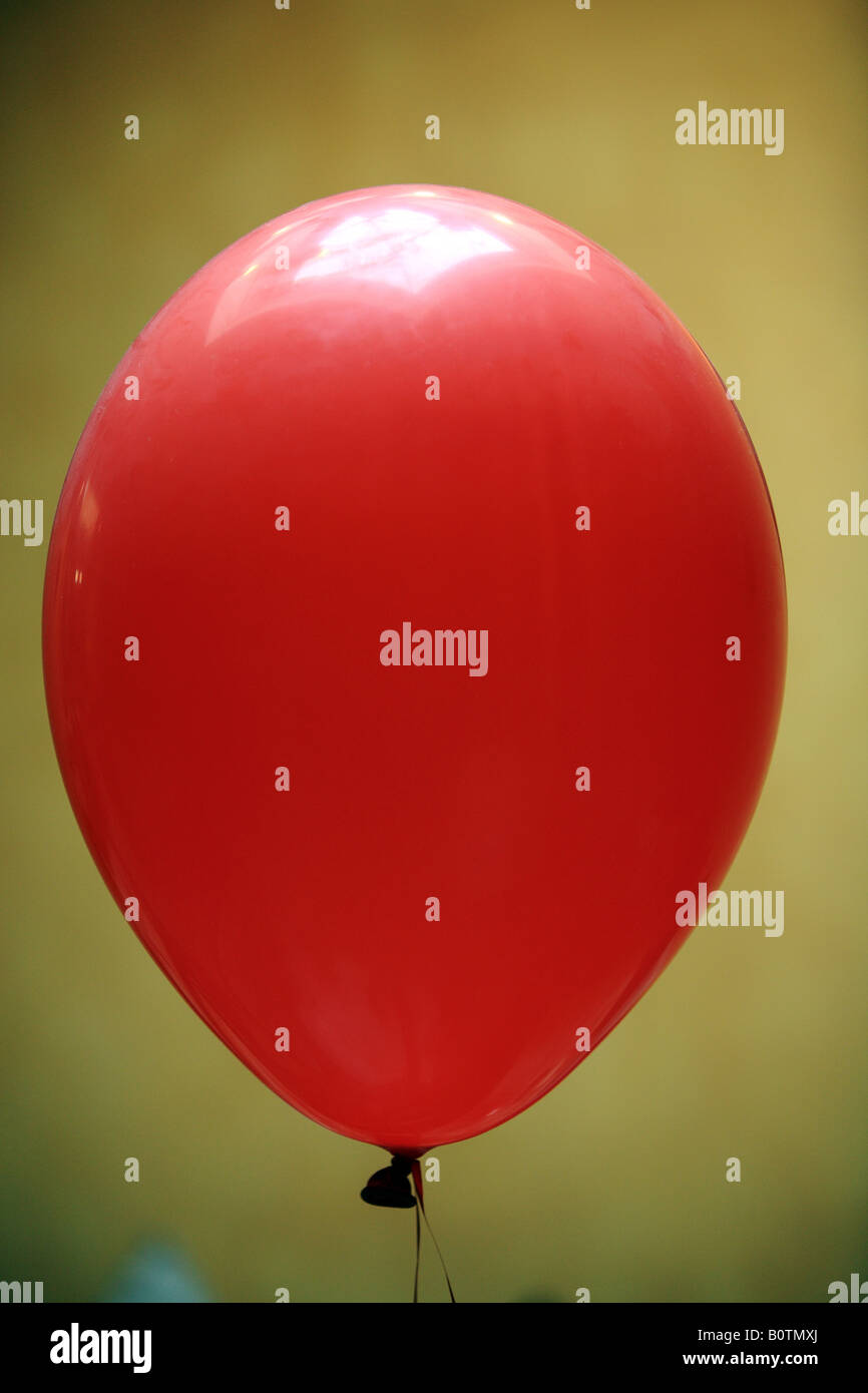 A red balloon, inflated with helium. Stock Photo