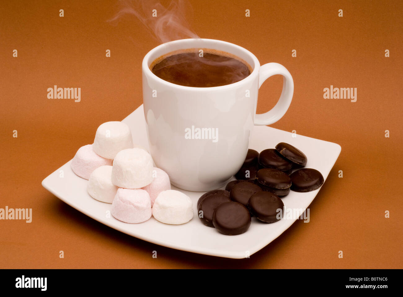 Cup of steaming hot chocolate with marshmallows and chocolate sweets. Stock Photo
