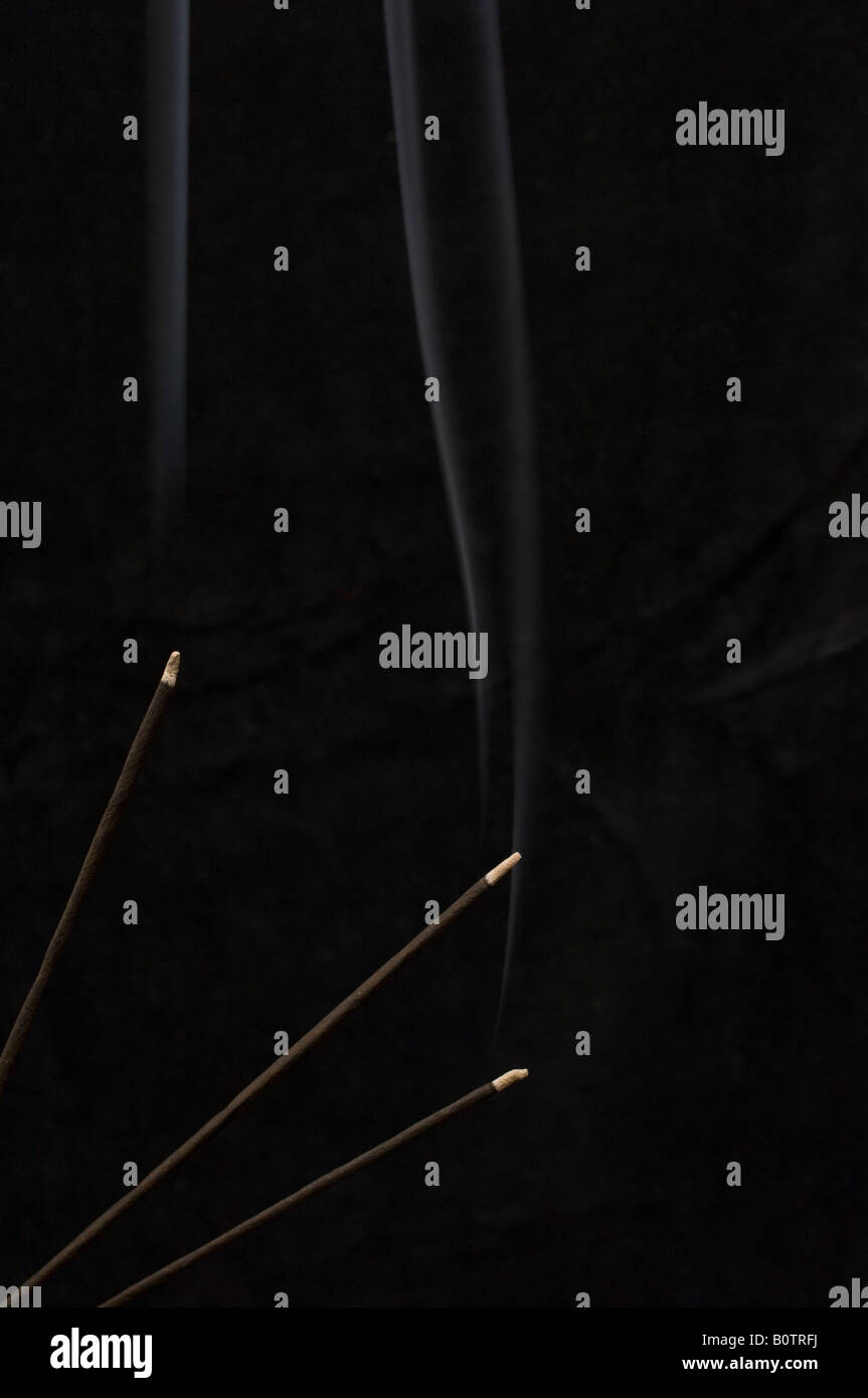 Burning Incense Sticks on a black background Stock Photo - Alamy