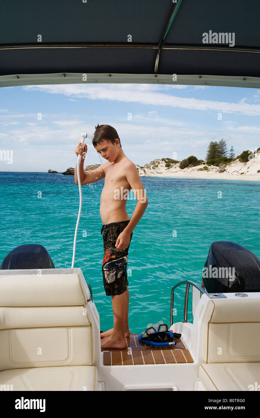 Boy taking a shower on boat Stock Photo Alamy