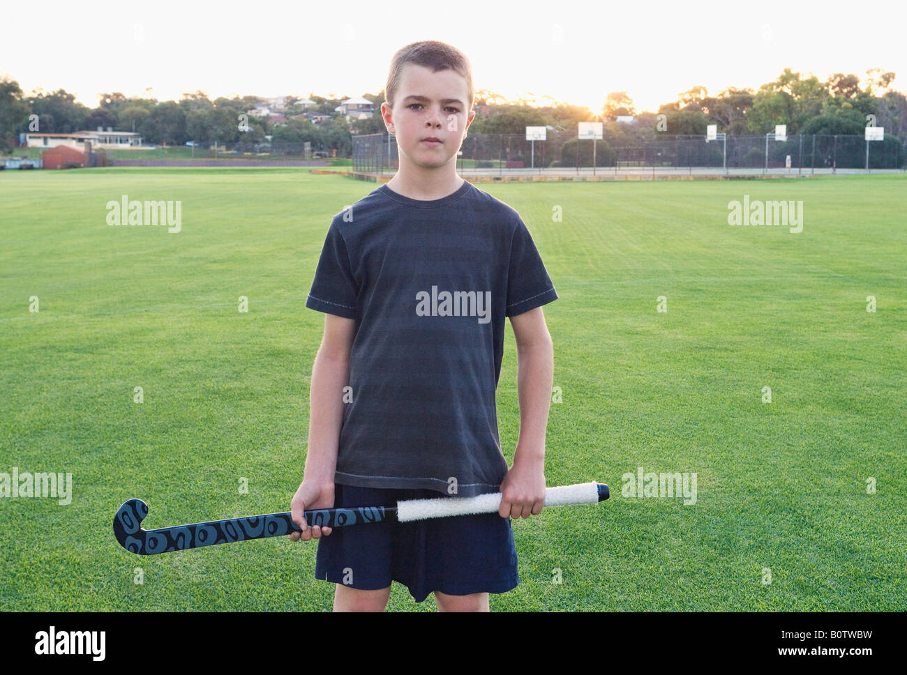 Boy holding hockey stick Stock Photo Alamy