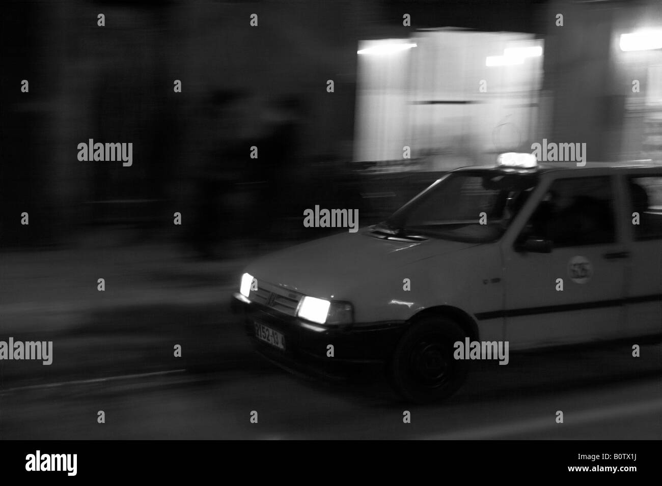 Petit taxi driving through streets of Marrakech Stock Photo