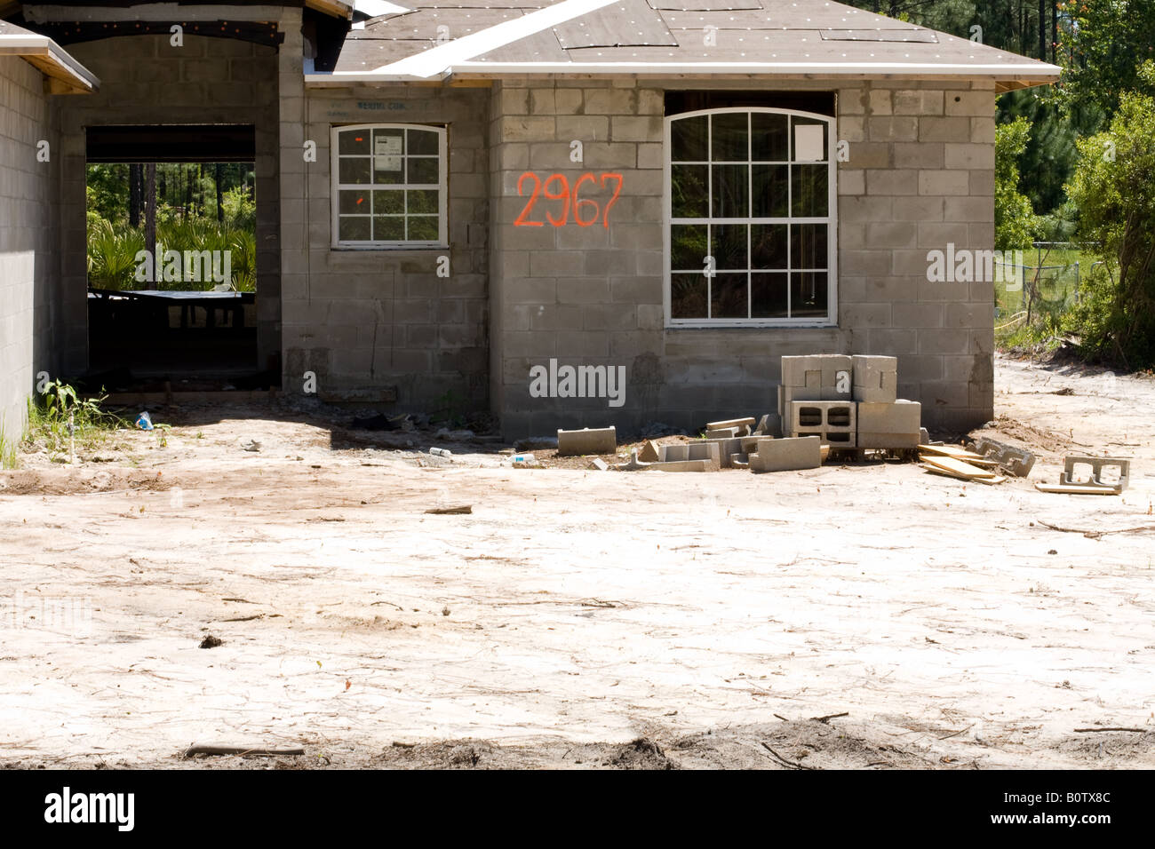 Cement block house under construction on a sand base Stock Photo - Alamy