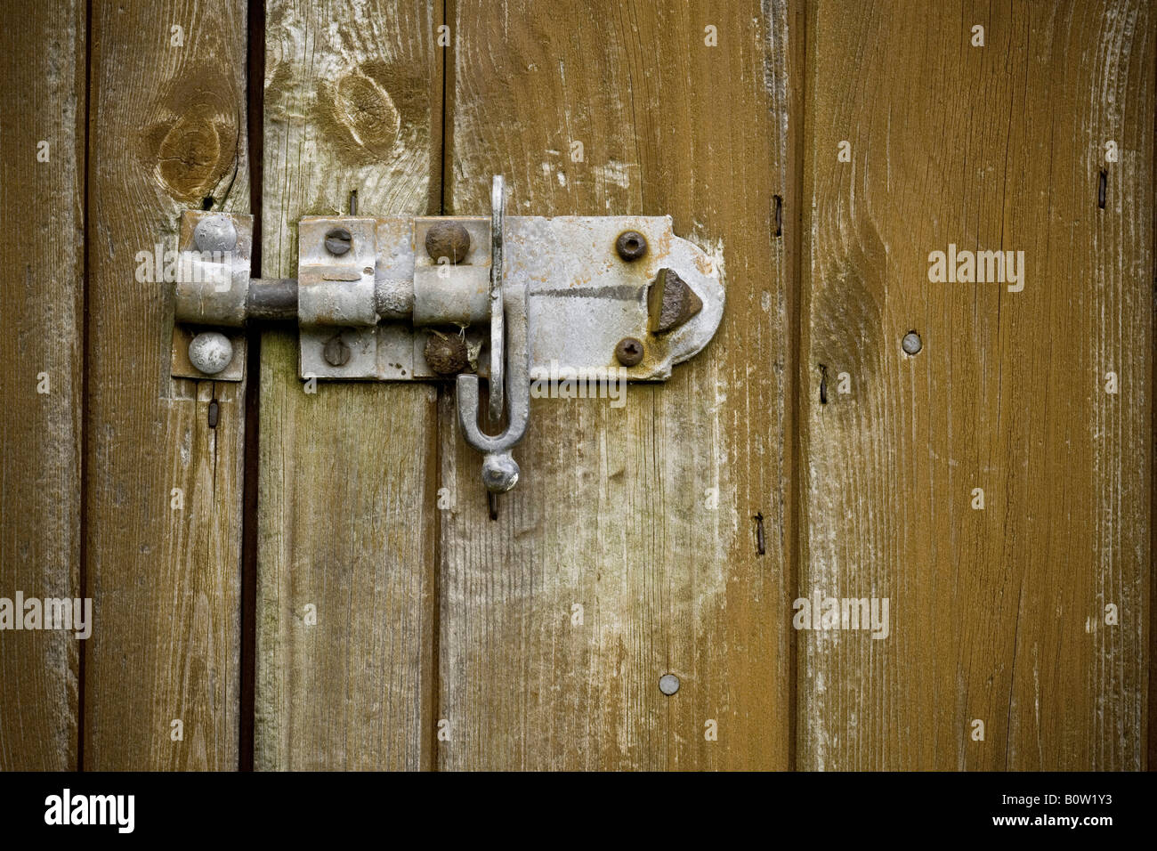 Old style bolt drawn across locking a shed Stock Photo Alamy