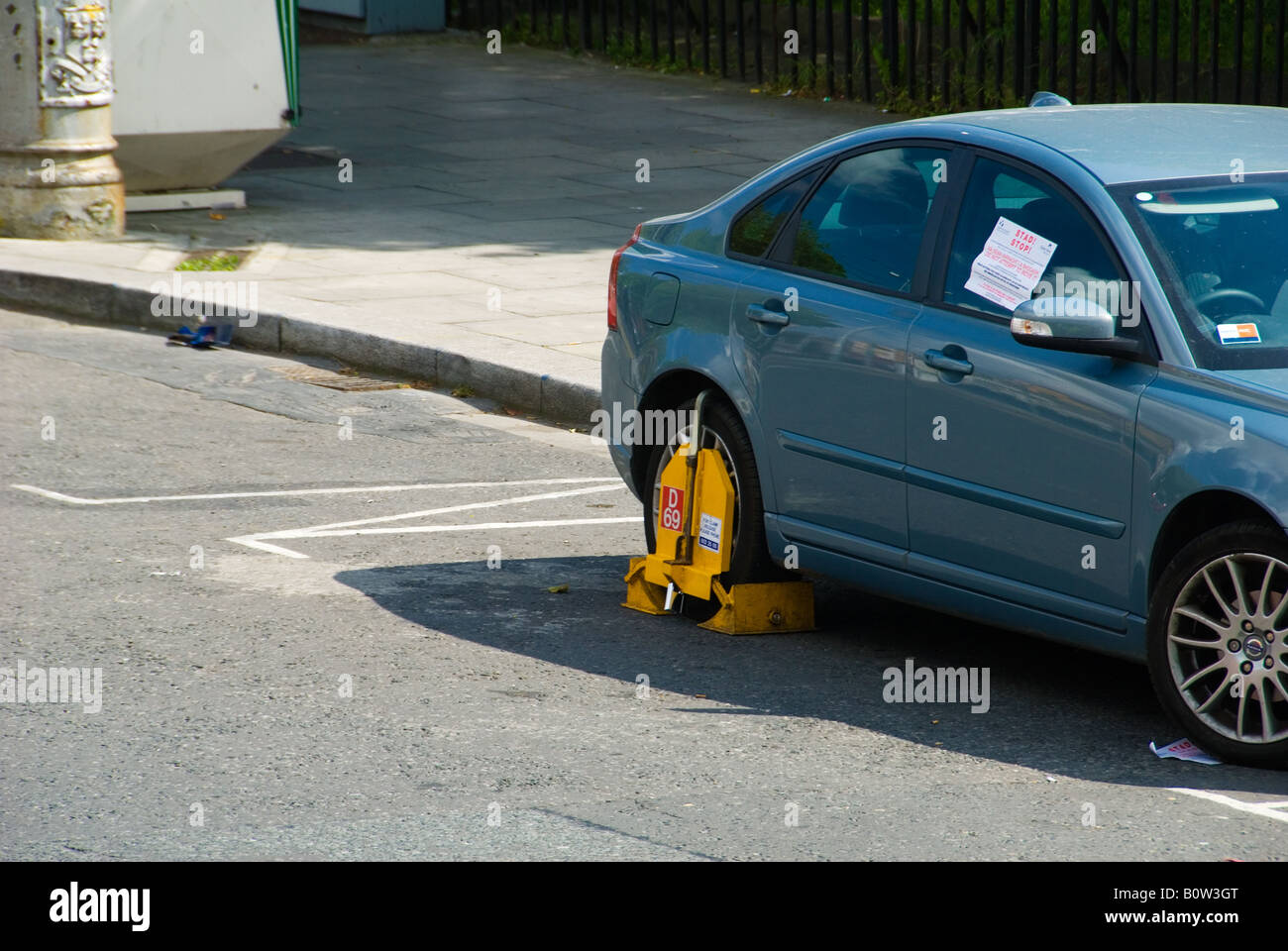 Wheel Clamp on an Illegally Parked Car Stock Photo