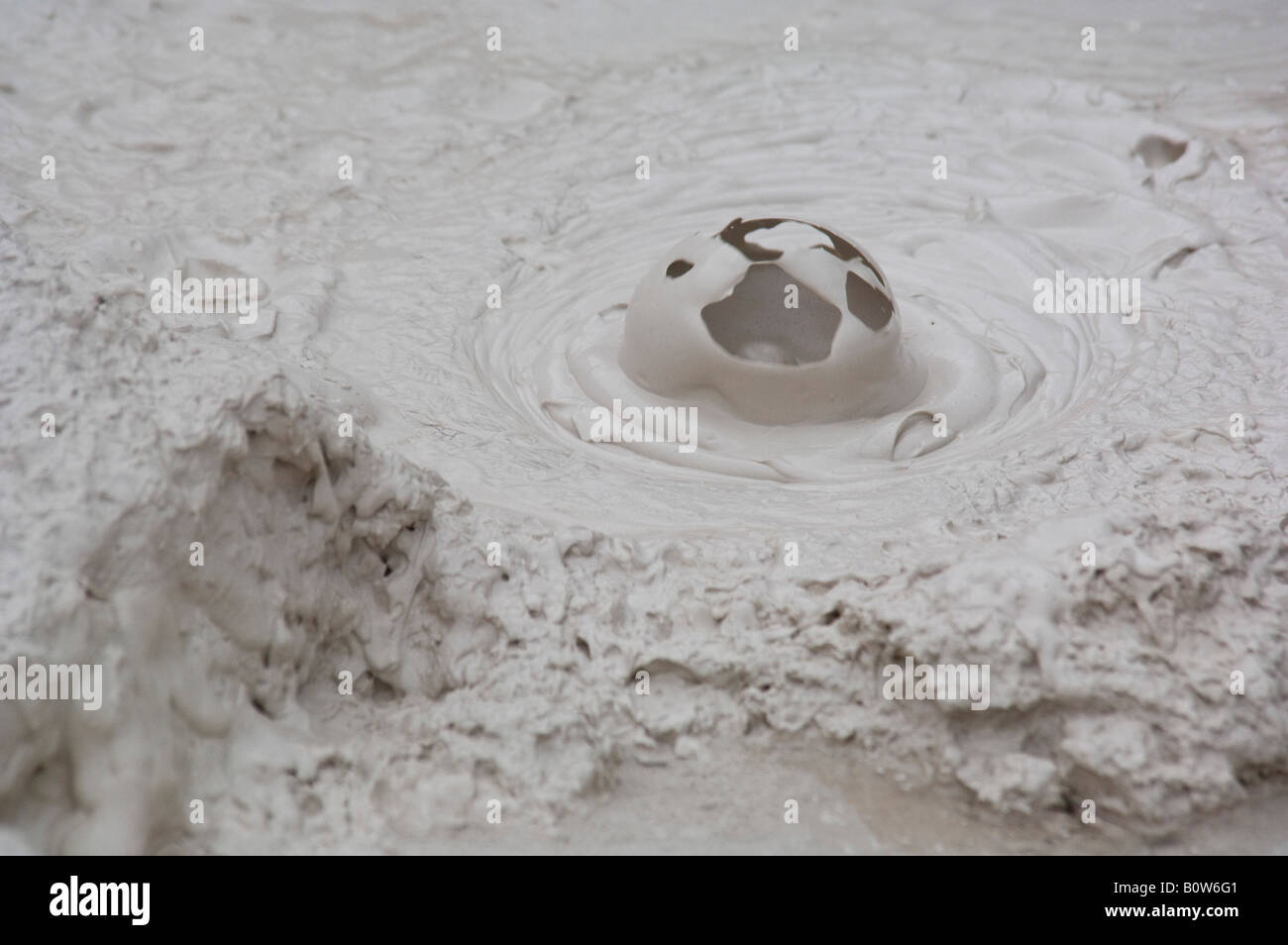 Mud bubble bursting in one of the Artists Paintpots near Norris Yellowstone National Park Wyoming Stock Photo