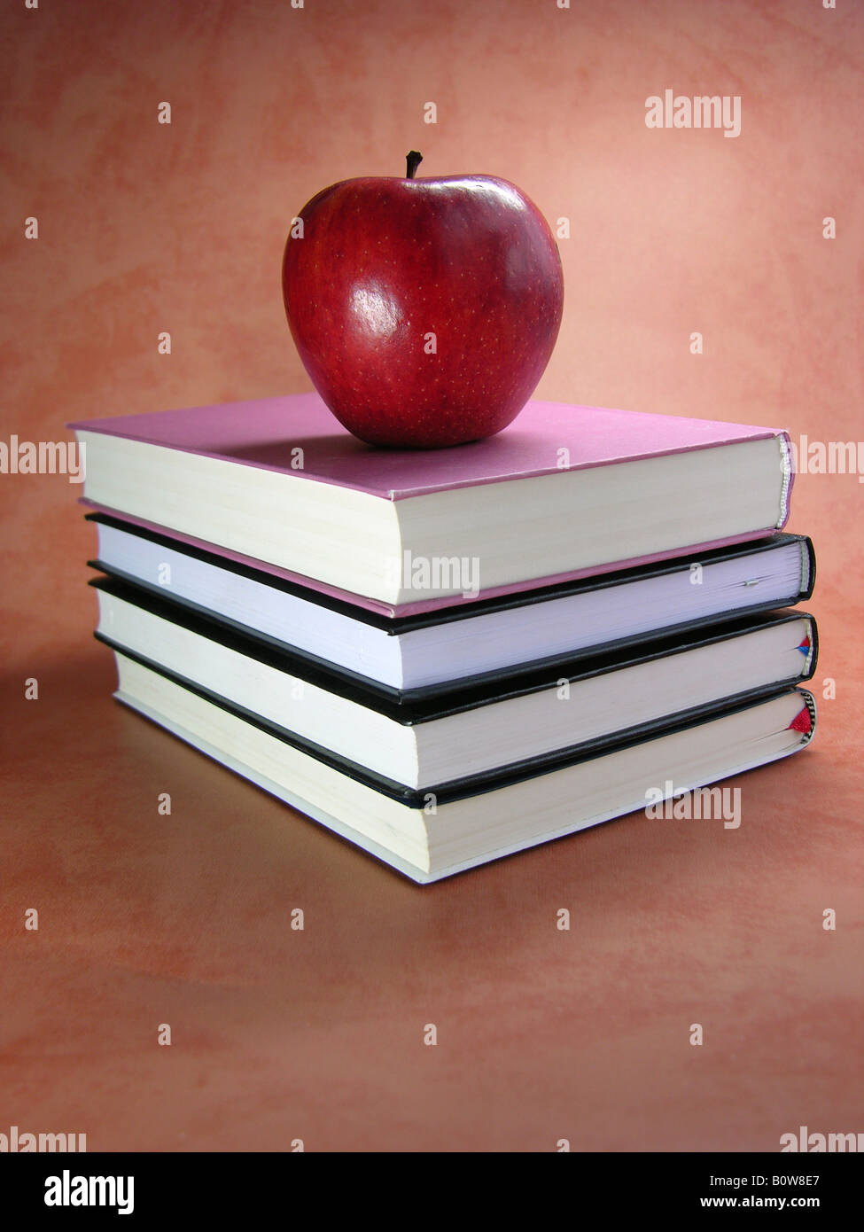 Red apple on top of a stack of books Stock Photo