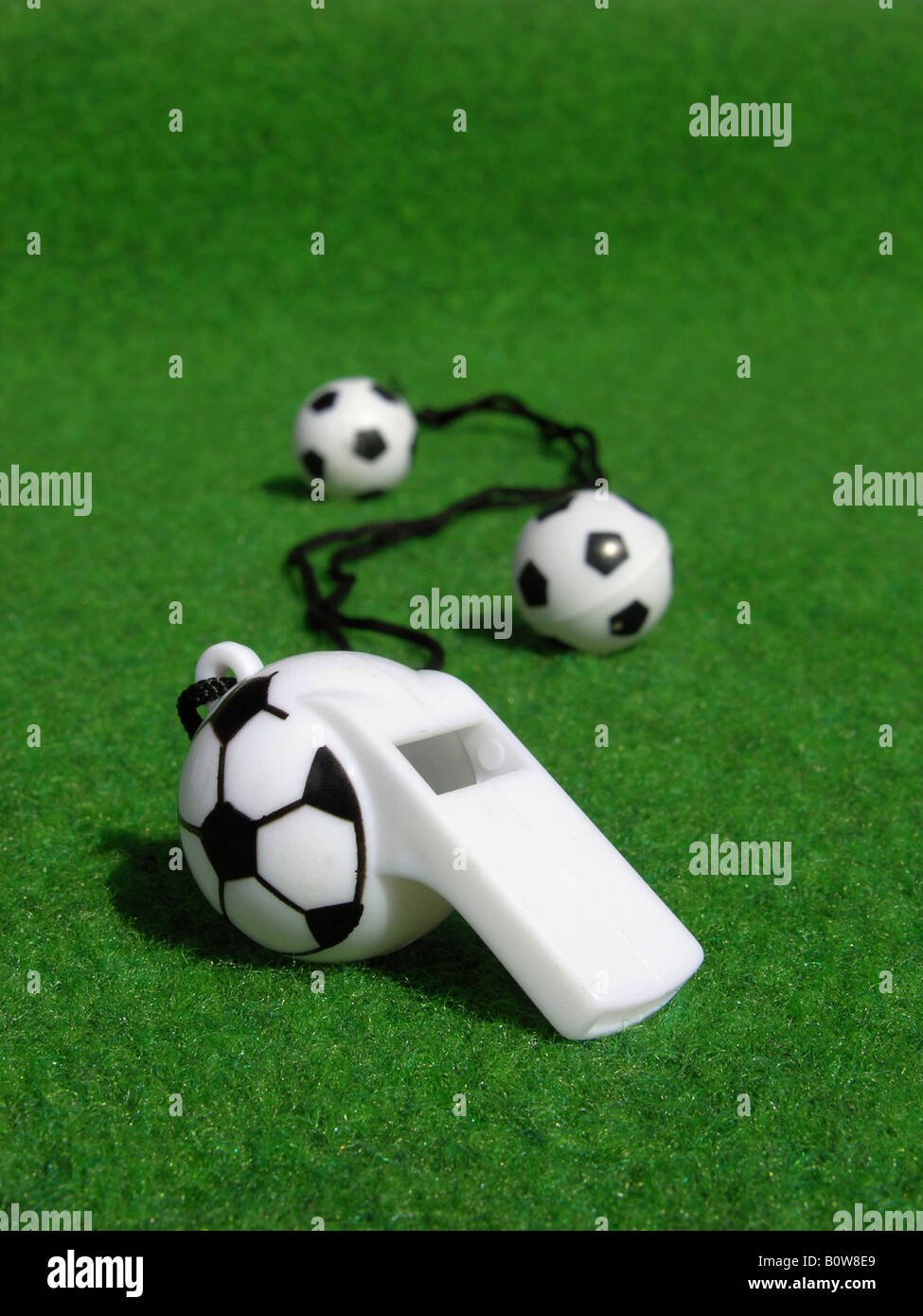 Miniature footballs, soccer balls, whistle on pitch Stock Photo Alamy