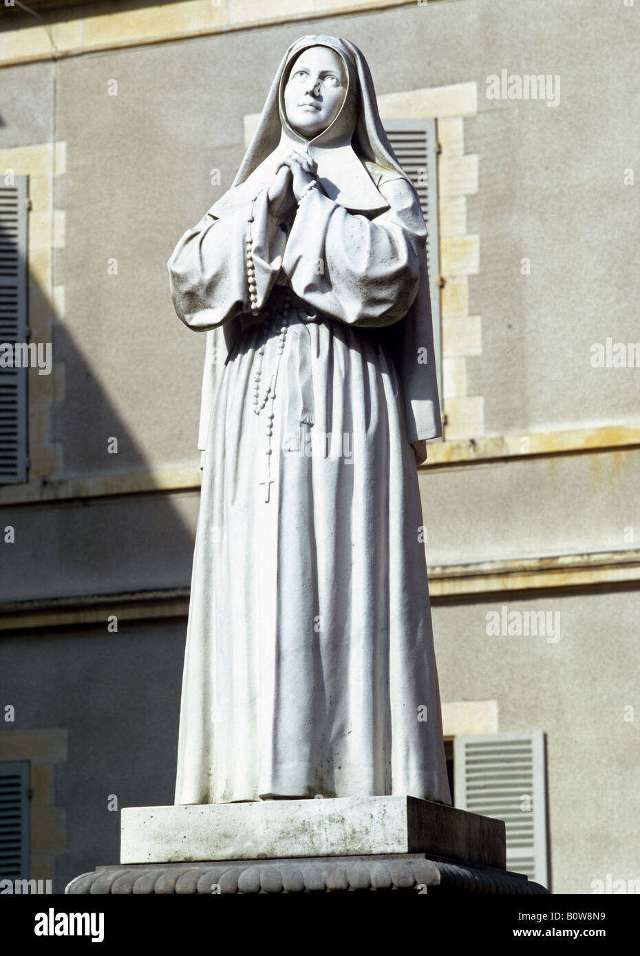Statue of St. Bernadette of Lourdes in the St. Gildard monastery garden, Nevers, Nievre Department, France, Europe Stock Photo