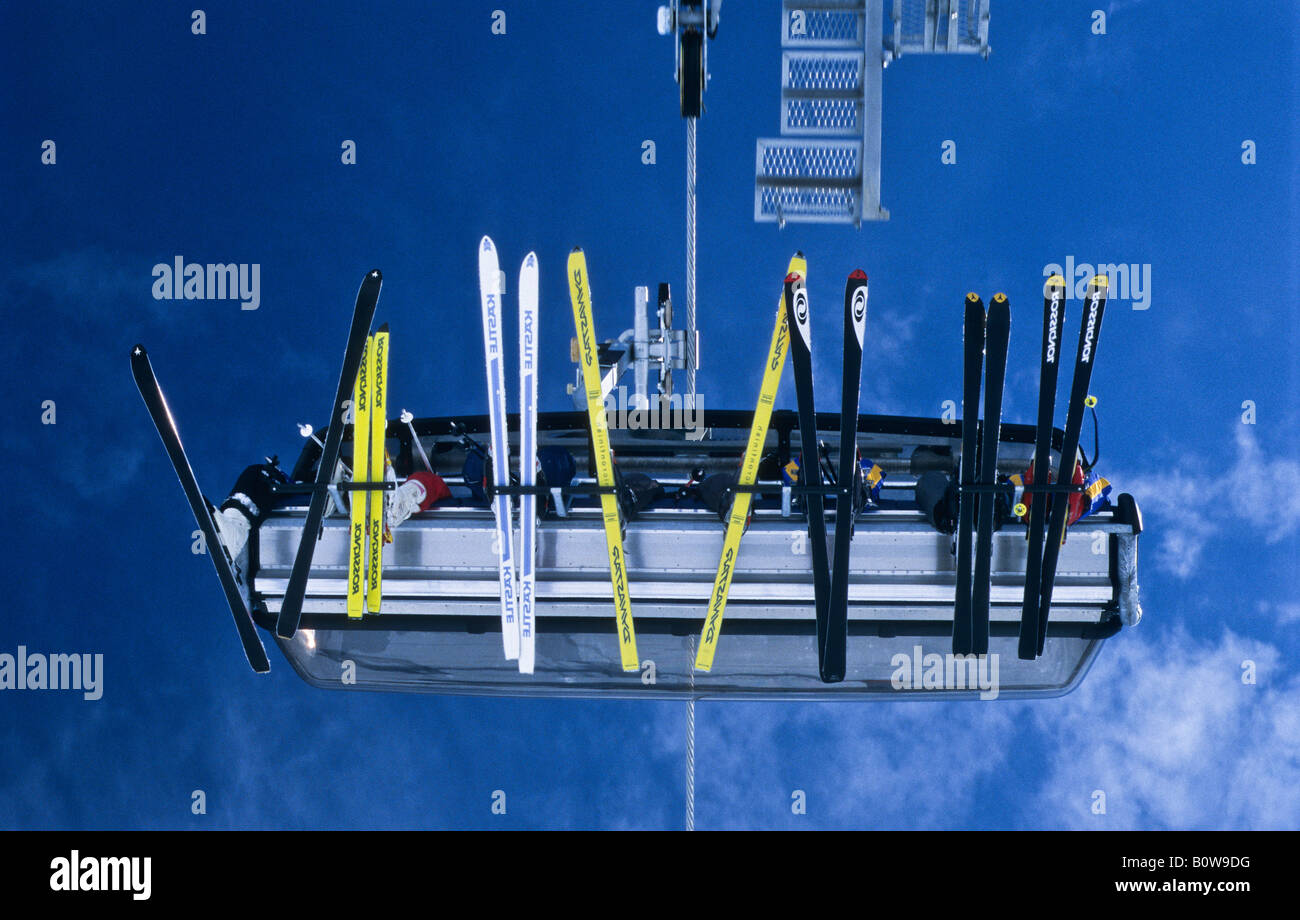 Seven skiers sitting on a chair of a chair lift, skis viewed from below, Ischgl, Idalpe, Tyrol, Austria, Europe Stock Photo