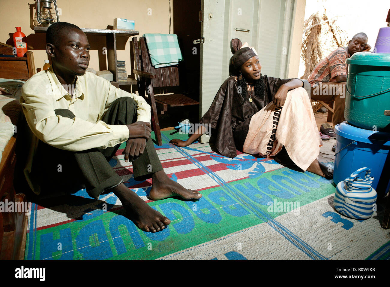 Man and woman sitting in a living room, Garoua, Cameroon, Africa Stock Photo