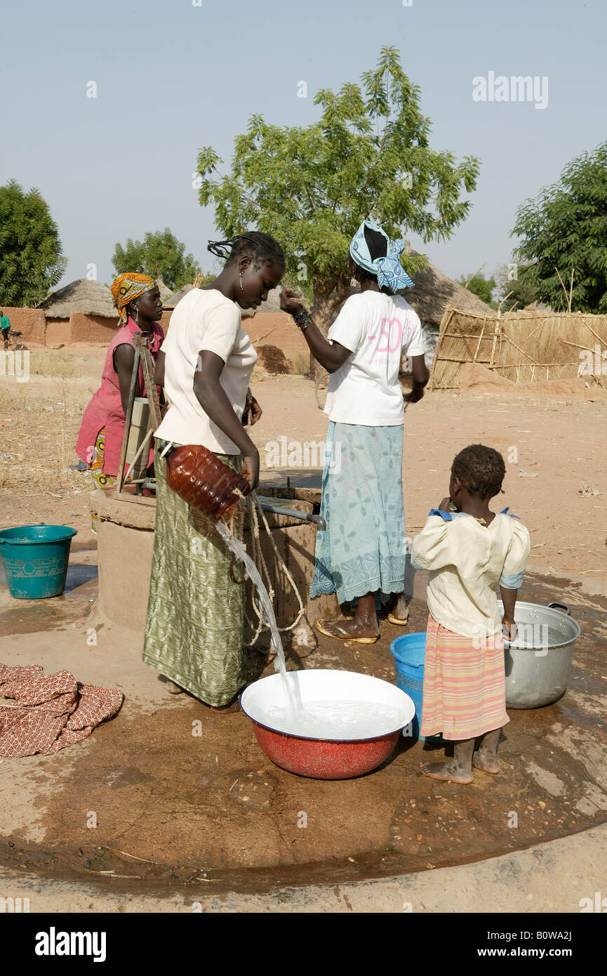 Women fetching water from a well, Cameroon, Africa Stock Photo Alamy