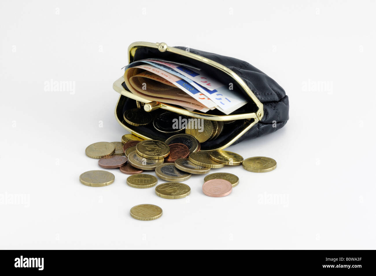 Red change purse filled with Euro coins and bills Stock Photo