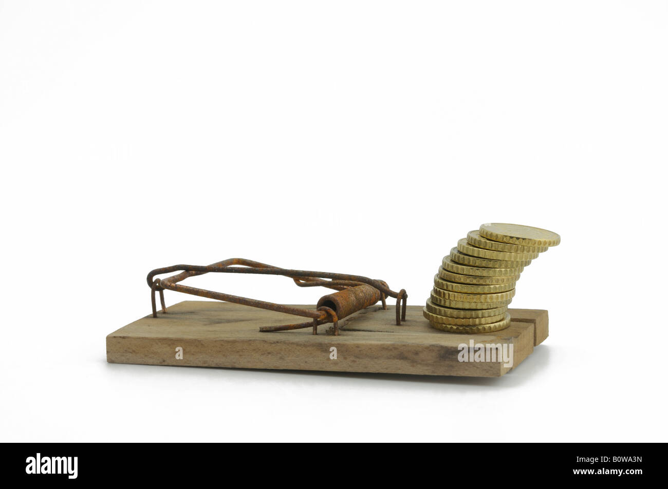 Set mousetrap with a stack of coins as bait Stock Photo