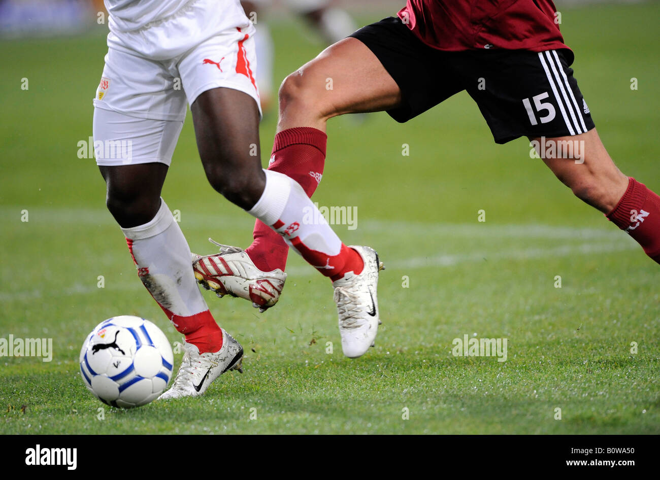 Arthur Boka, VfB Stuttgart footballer on the left tackling Jan Kristiansen, 1. FC Nuremberg player on the right, tackle Stock Photo