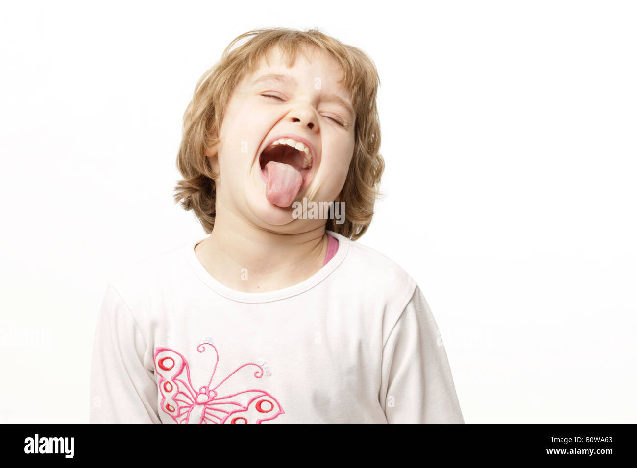 8-year-old girl sticking her tongue out Stock Photo