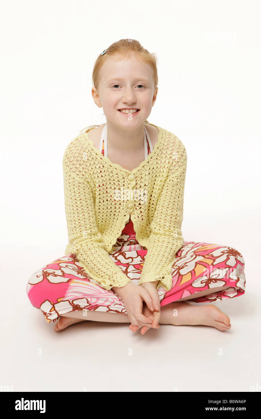8-year-old girl wearing a dress, barefoot, sitting cross-legged Stock Photo  - Alamy