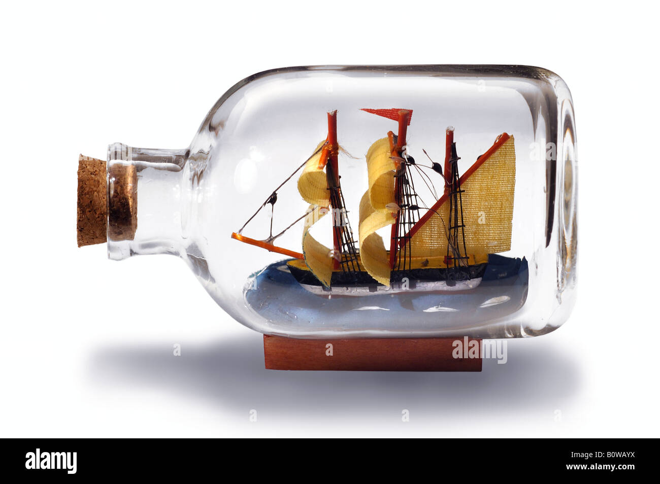 Small sailing ship model in a transparent bottle, stopped with a cork Stock Photo