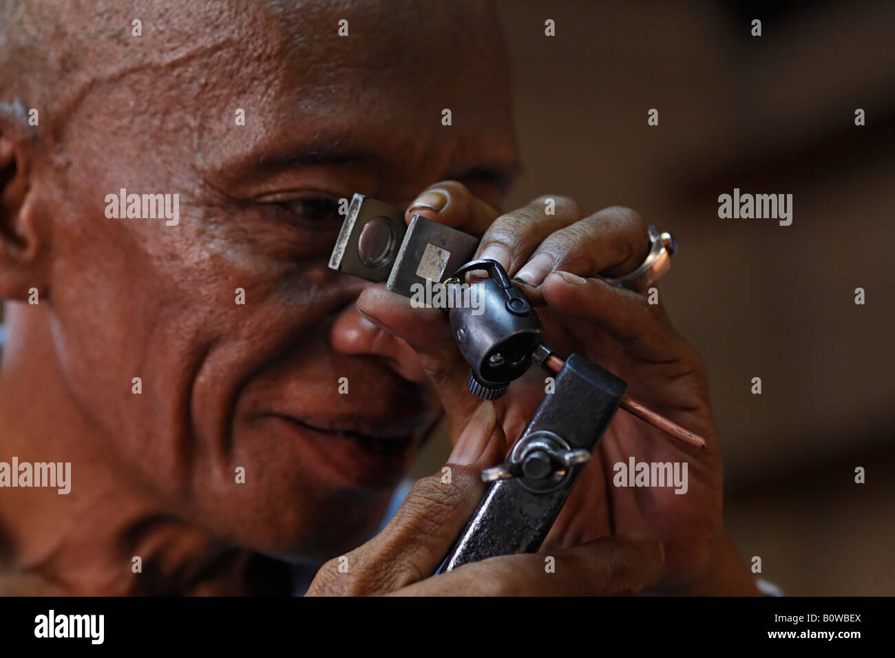 Man checking the quality of a diamond's cut, diamond cutting, Cempaka, South Kalimantan, Borneo, Indonesia, Asia Stock Photo