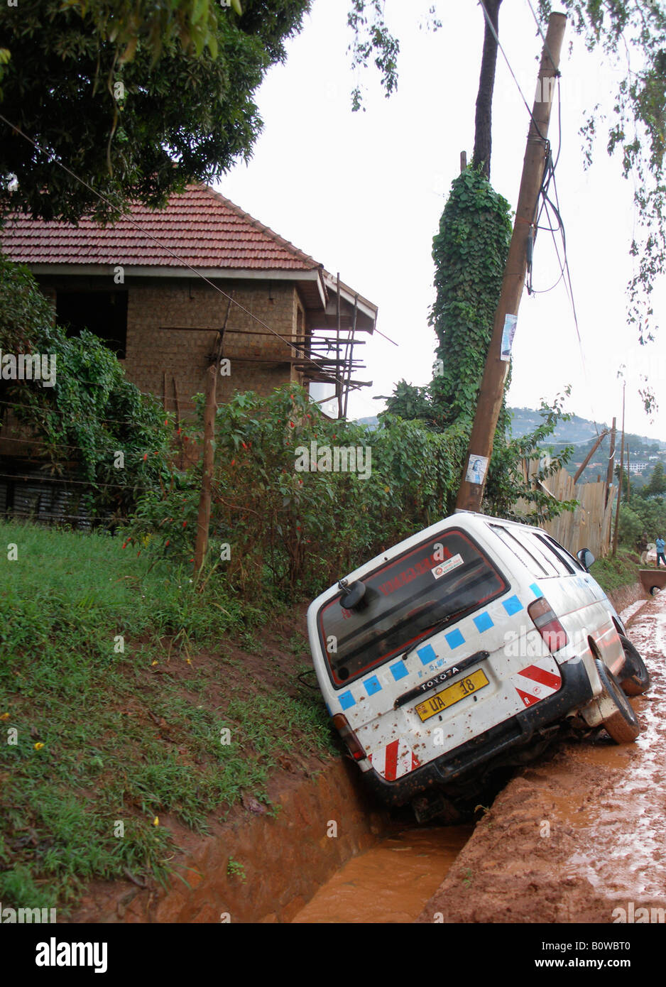 Minibus taxi (matatu) after sliding off the road and into a ditch in Kampala, Uganda Stock Photo