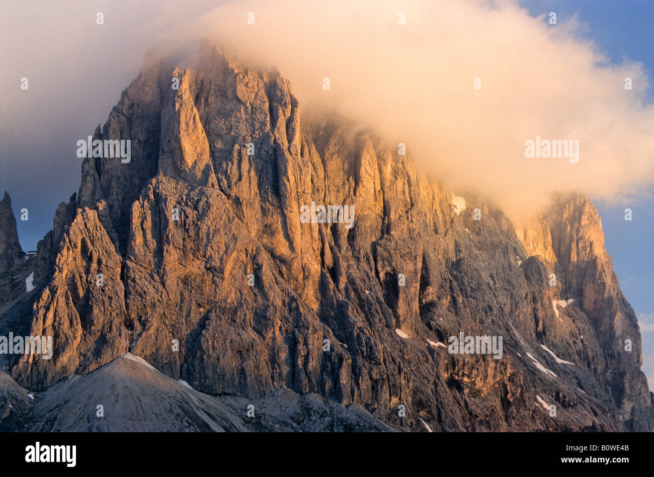 Rock face of Mt. Langkofel, wispy clouds in pale evening light, Dolomites, Bolzano-Bozen, Italy, Europe Stock Photo
