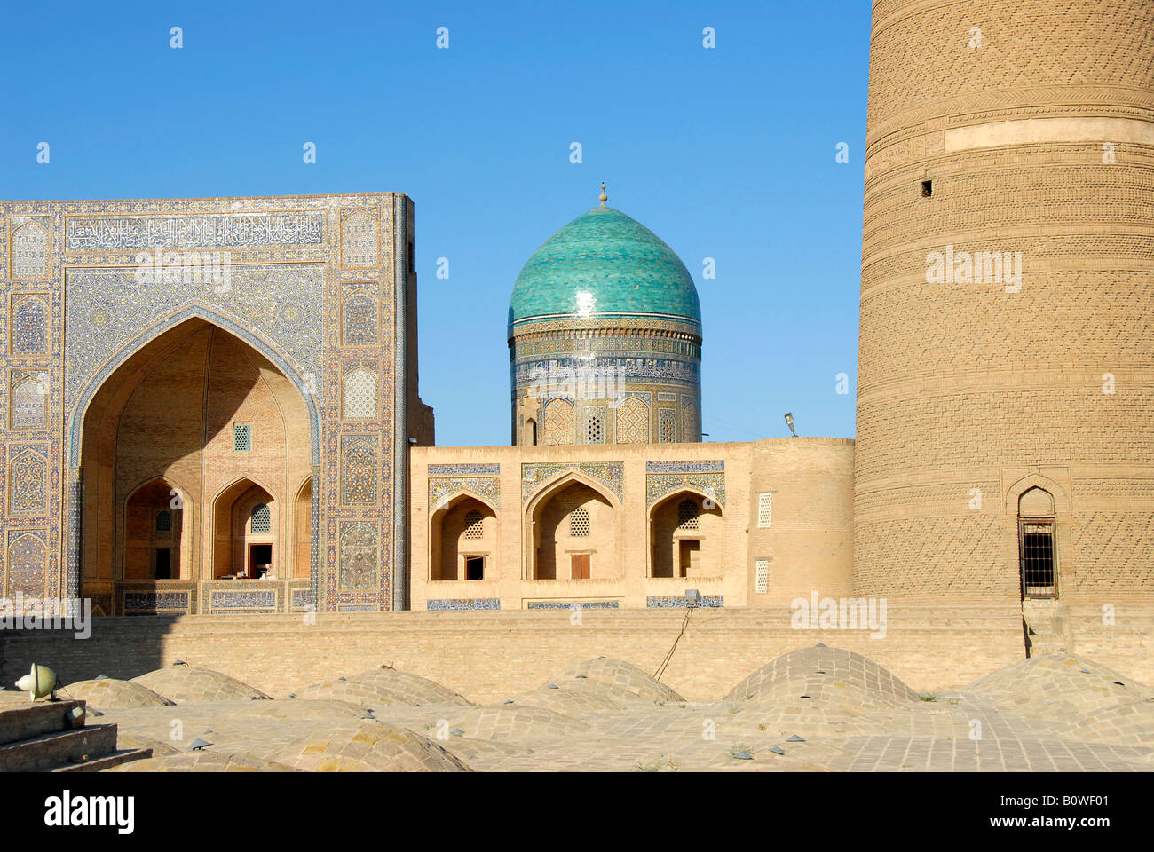 Iwan, eyvan of the Miri Arab Madrasah viewed over the rooftop of the Kalon Mosque, Buchara, Uzbekistan, Central Asia Stock Photo