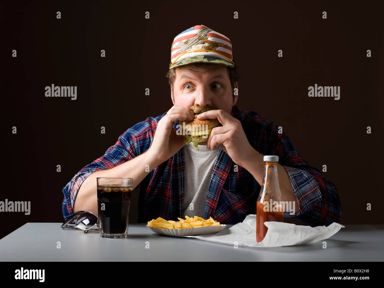 Stereotypical American man eating a burger Stock Photo Alamy