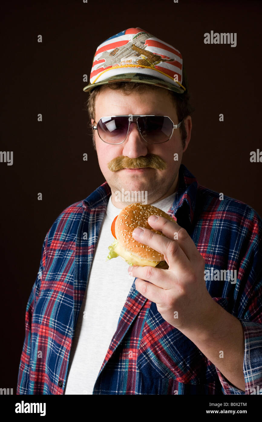 Stereotypical American man holding a hamburger Stock Photo - Alamy