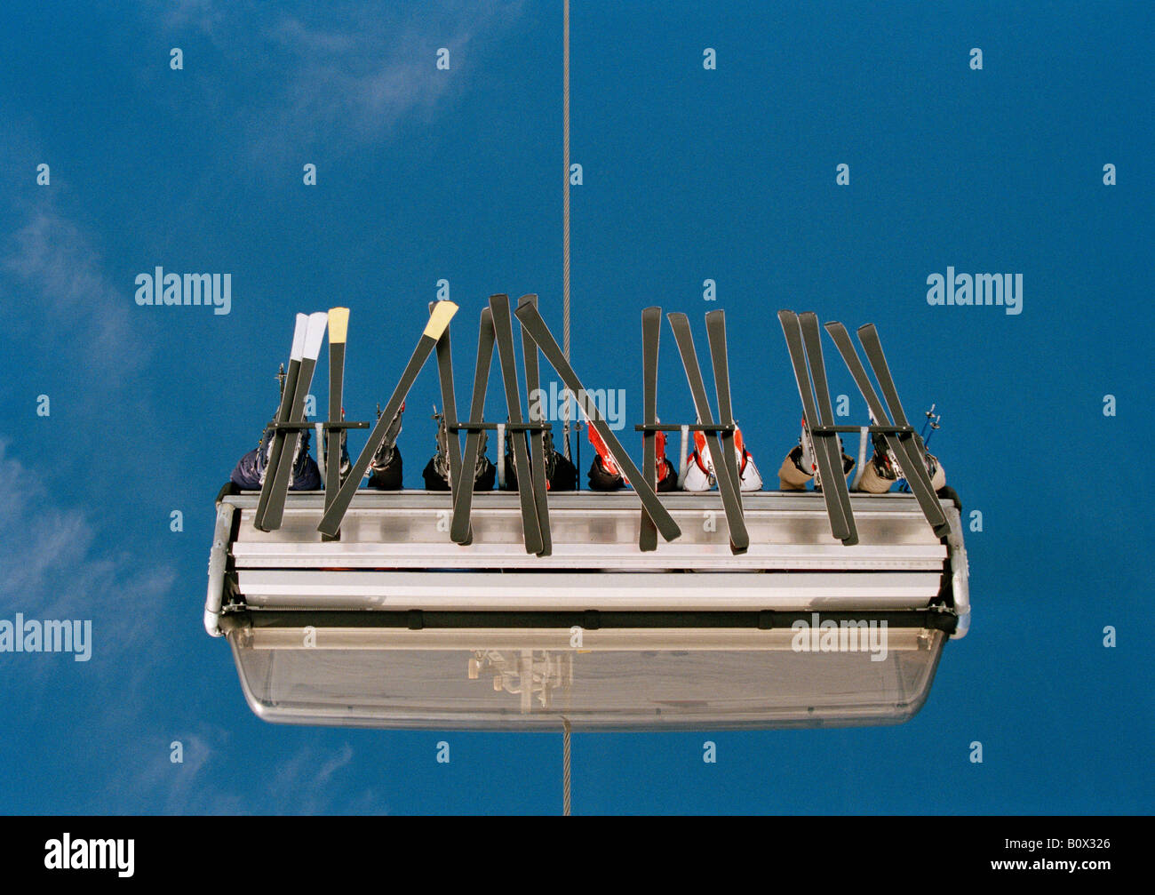 Low angle view of skiers sitting on a ski lift Stock Photo