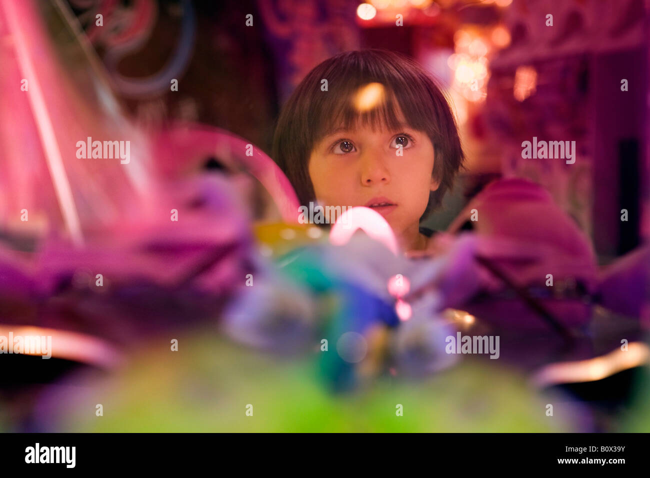 A boy surrounded by colorful lights Stock Photo