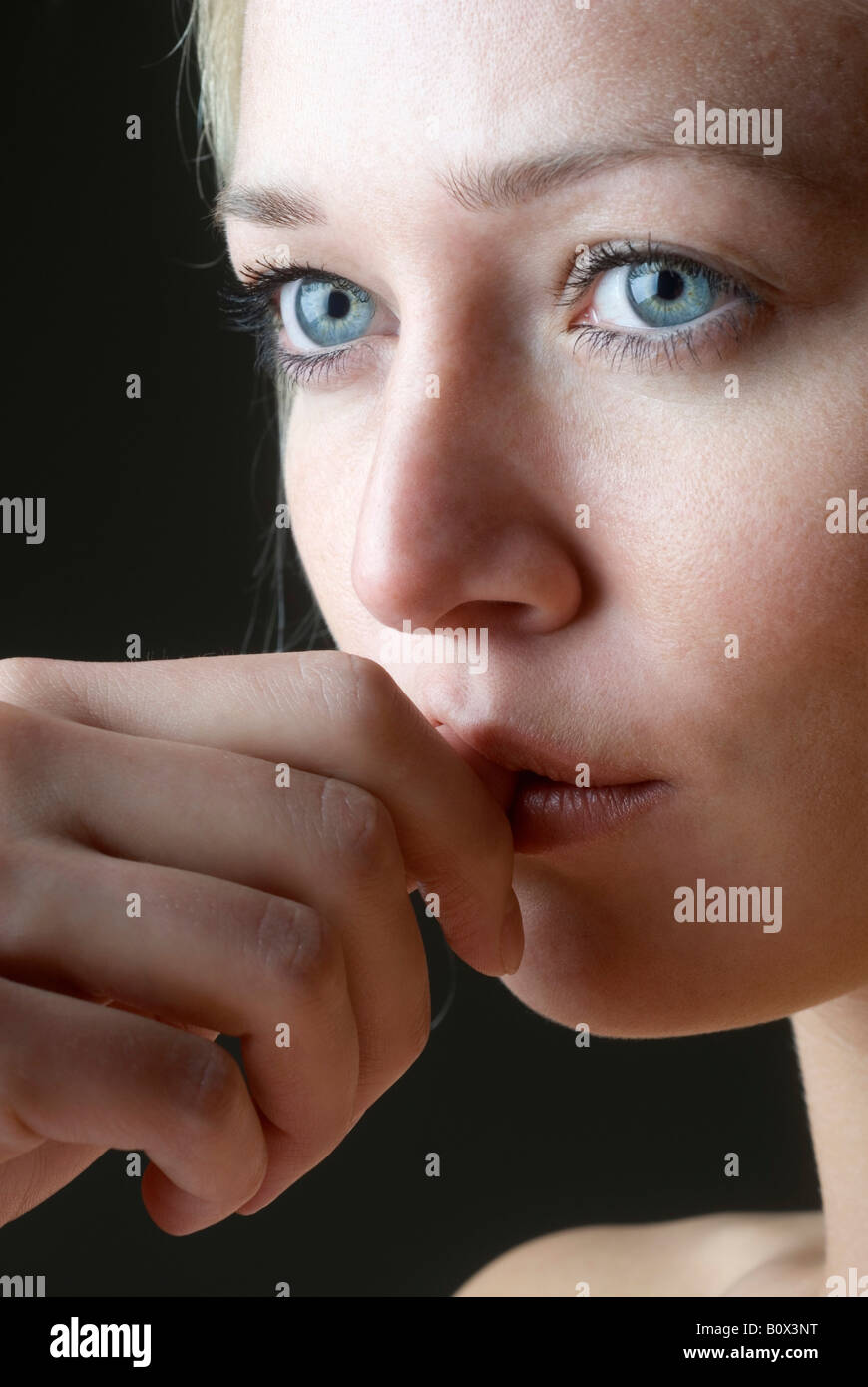 Close up of a woman biting her nail Stock Photo