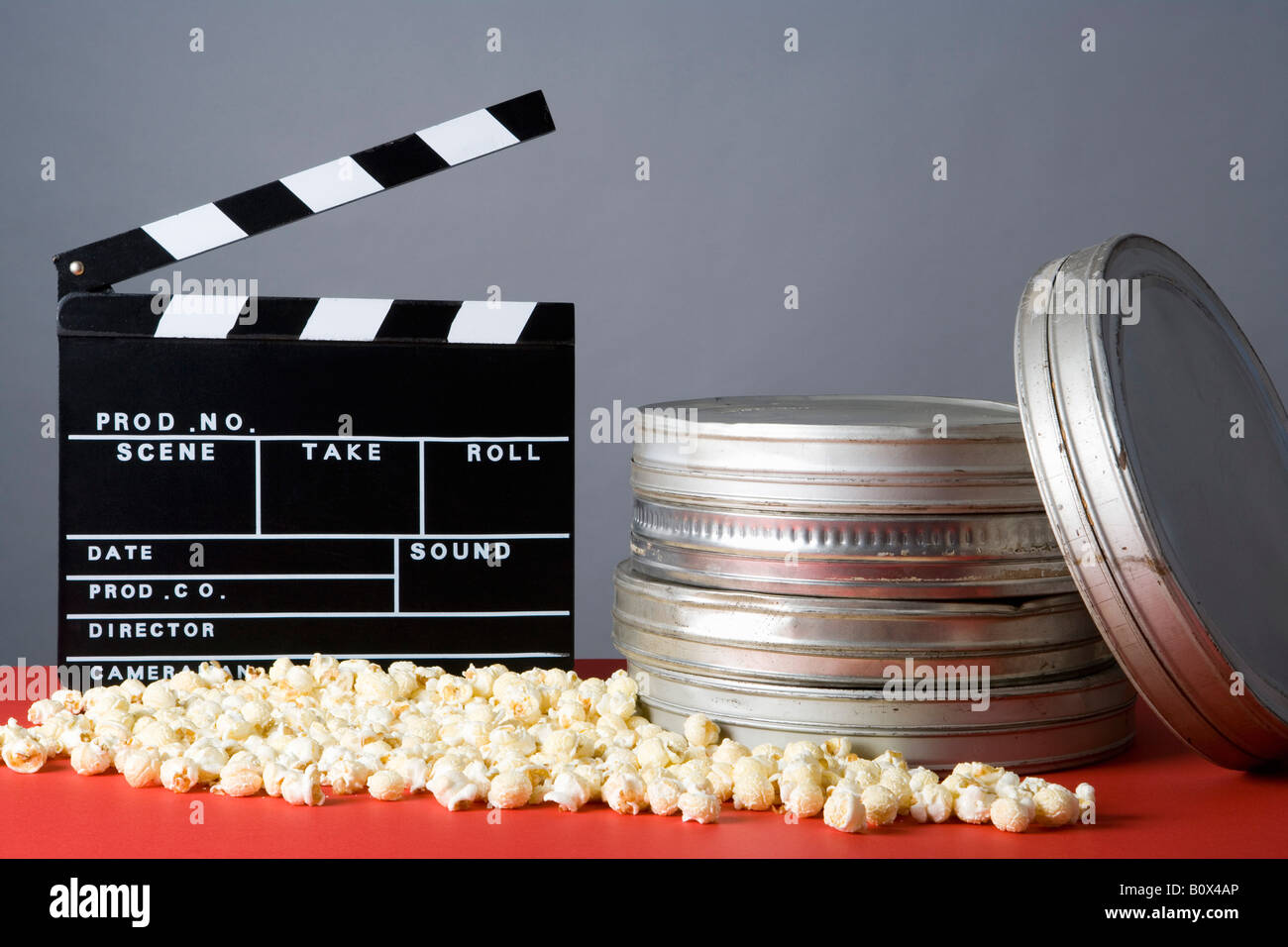 Clapperboard, popcorn and film reels Stock Photo