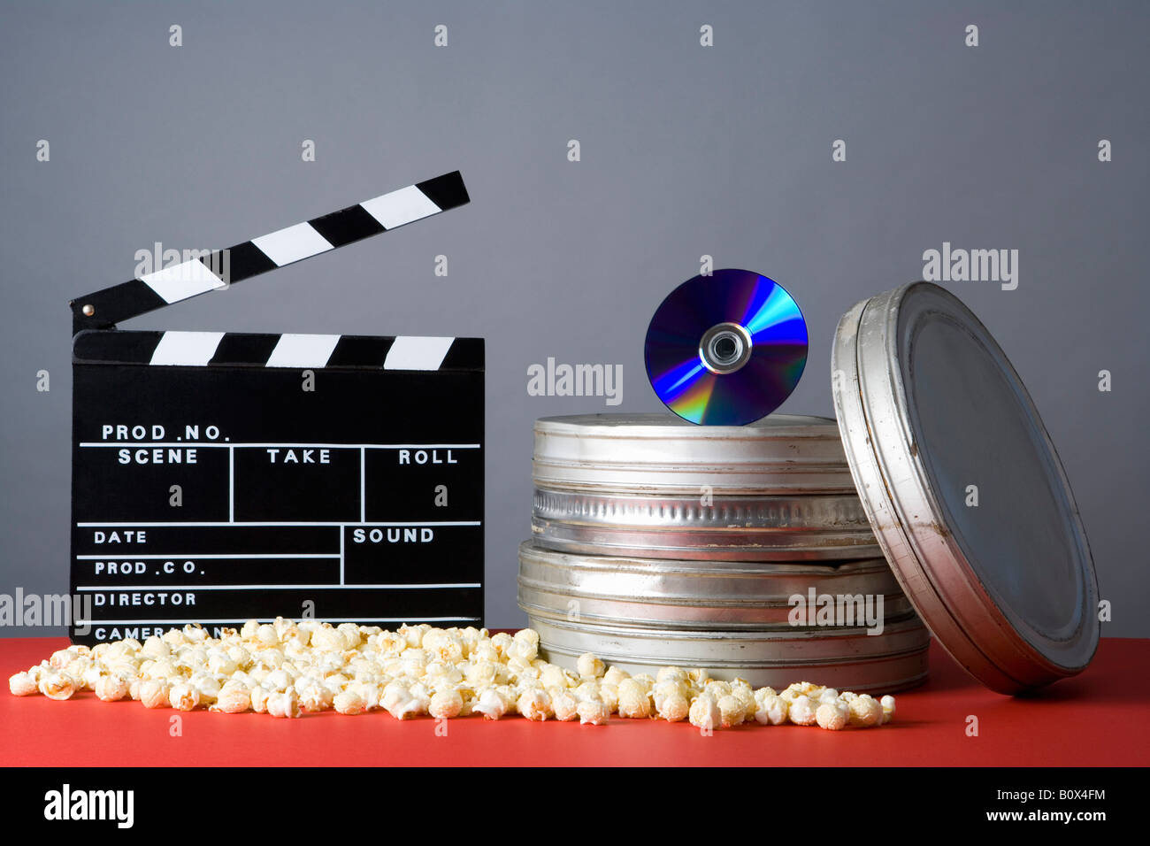 Clapperboard, popcorn, film reels and CD Stock Photo