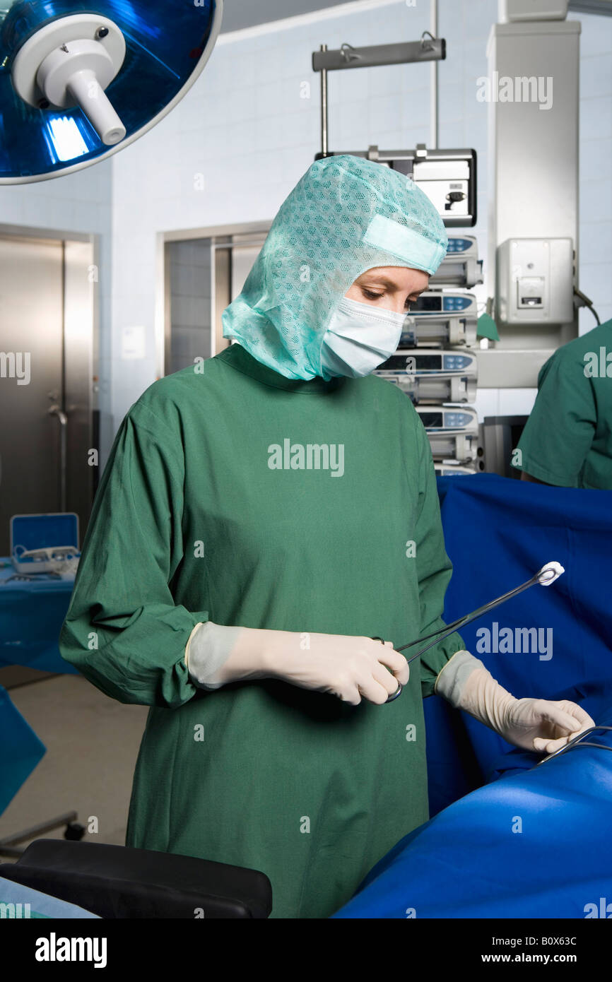 A surgeon operating on a patient Stock Photo - Alamy