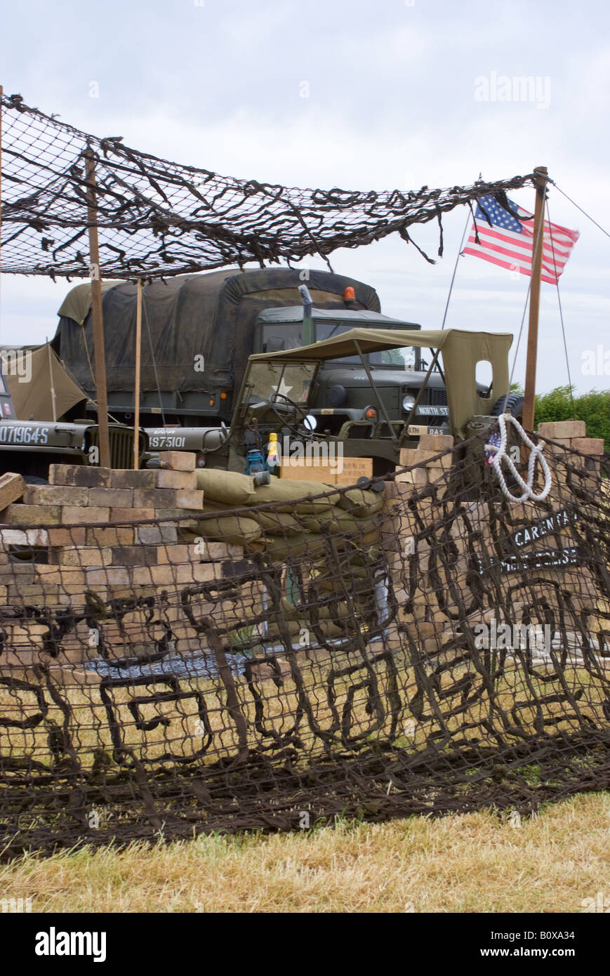 Two United States Army Jeeps and a Reo M35 Truck at Camouflaged Camp at Smallwood Vintage Rally Cheshire England UK Stock Photo