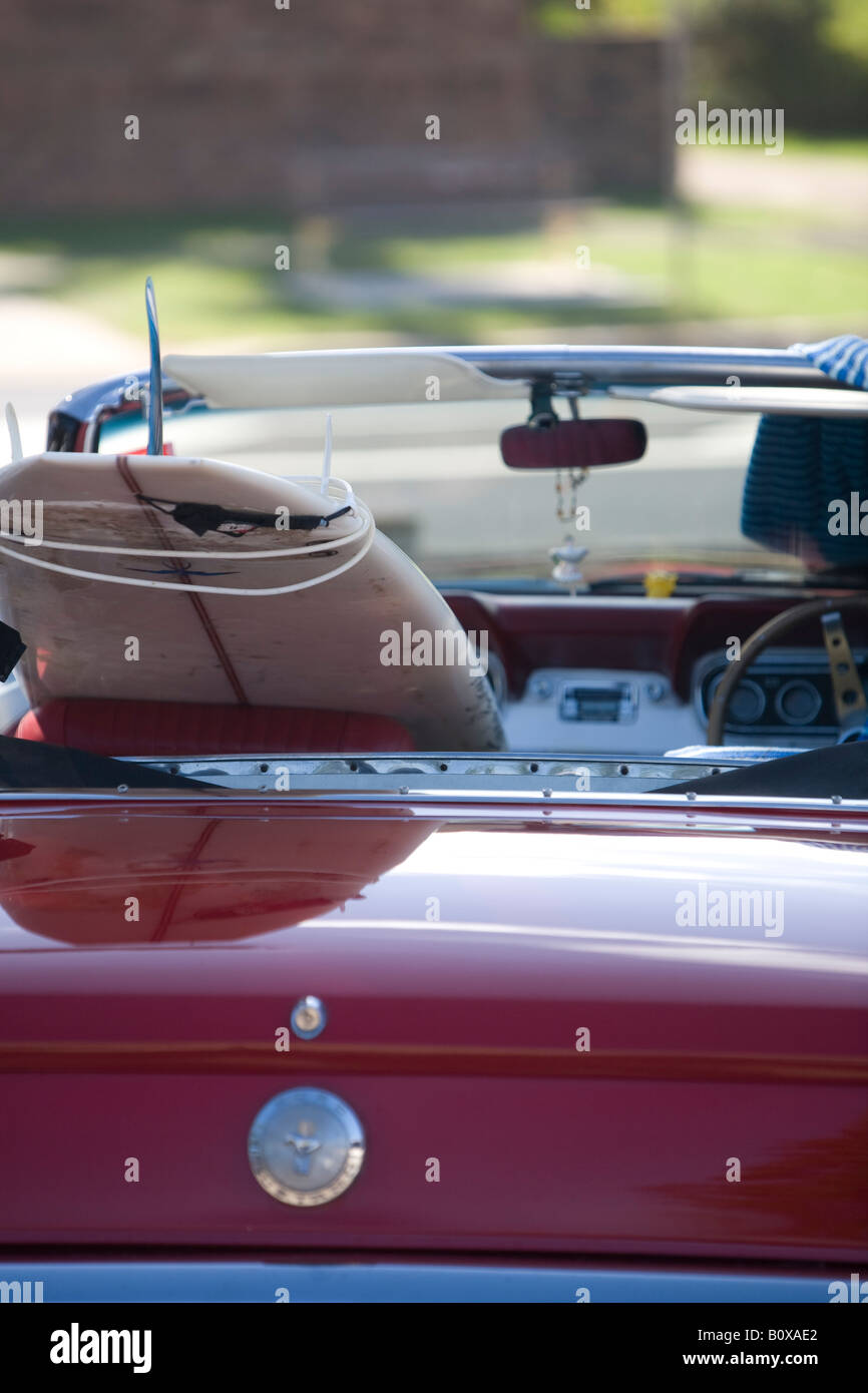 surfboard in a 1966 model red convertible ford mustang,sydney ,australia Stock Photo