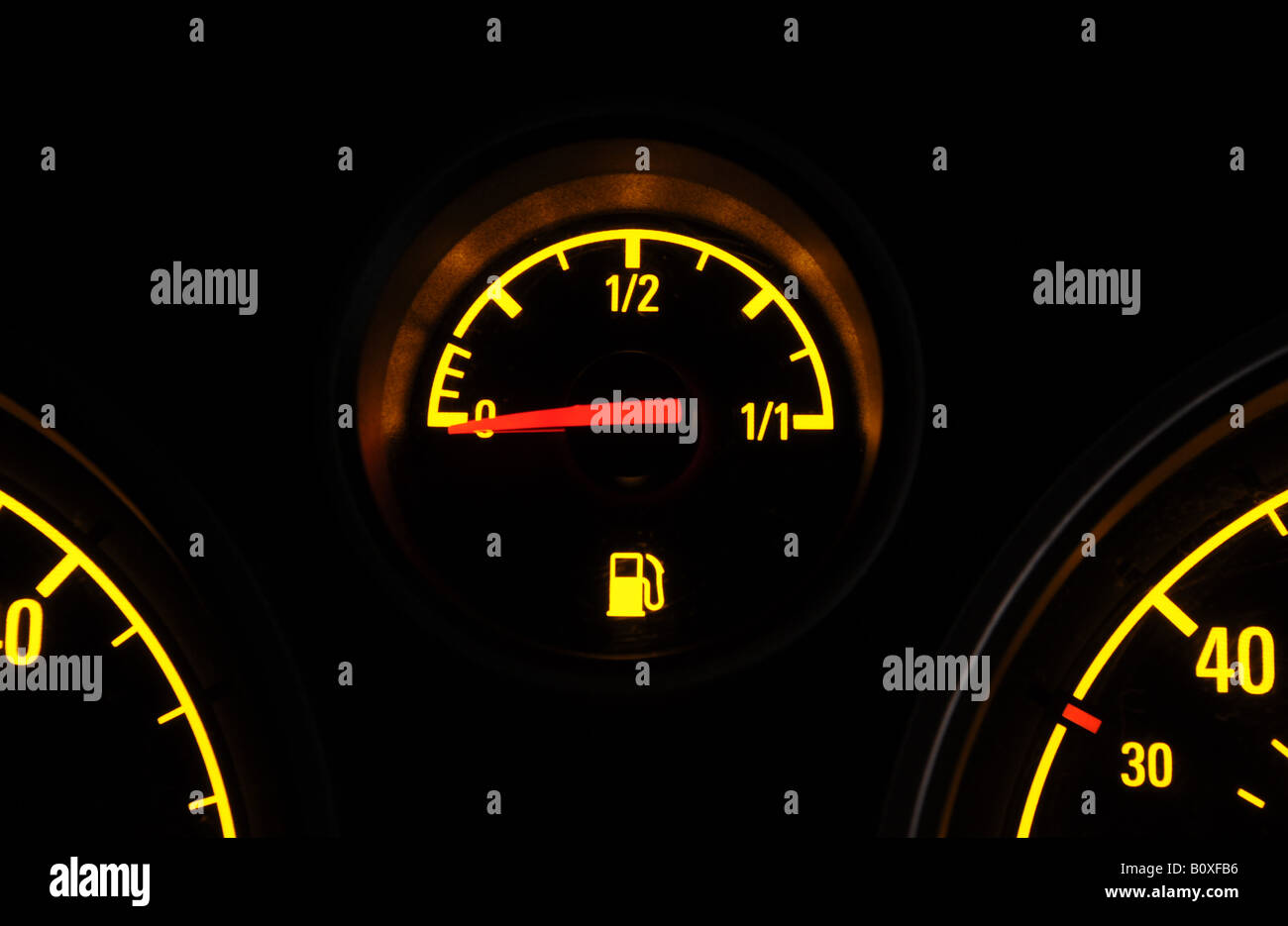 A BRITISH CAR FUEL GAUGE SHOWING LOW FUEL WITH  WARNING LIGHT,UK. Stock Photo