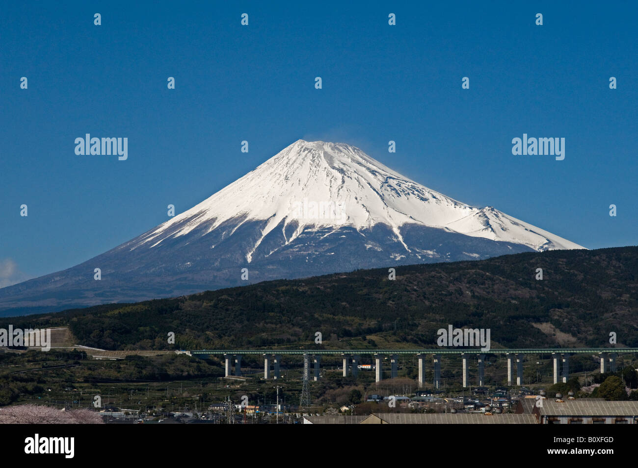 Japan. A view of Mount Fuji from the shinkansen (bullet train), with a motorway viaduct in the foreground Stock Photo