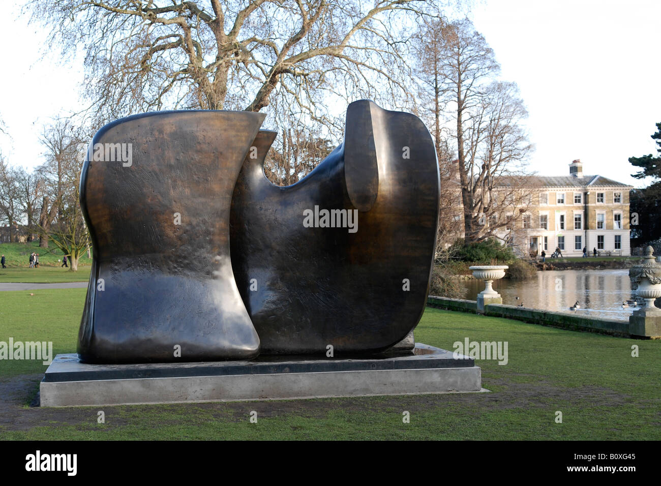 Henry Moore sculpture figure in two pieces , Knife Edge , completed in 1965 with lake and Plants